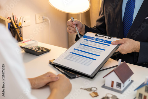 Tableau sur toile A man is pointing to a piece of paper that says insurance