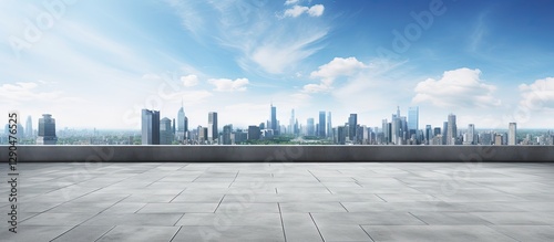 Panoramic city skyline view with modern buildings under a bright blue sky, open concrete plaza in foreground with ample copy space on stone tiles.