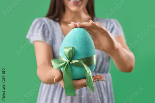 Woman holding large blue ea...