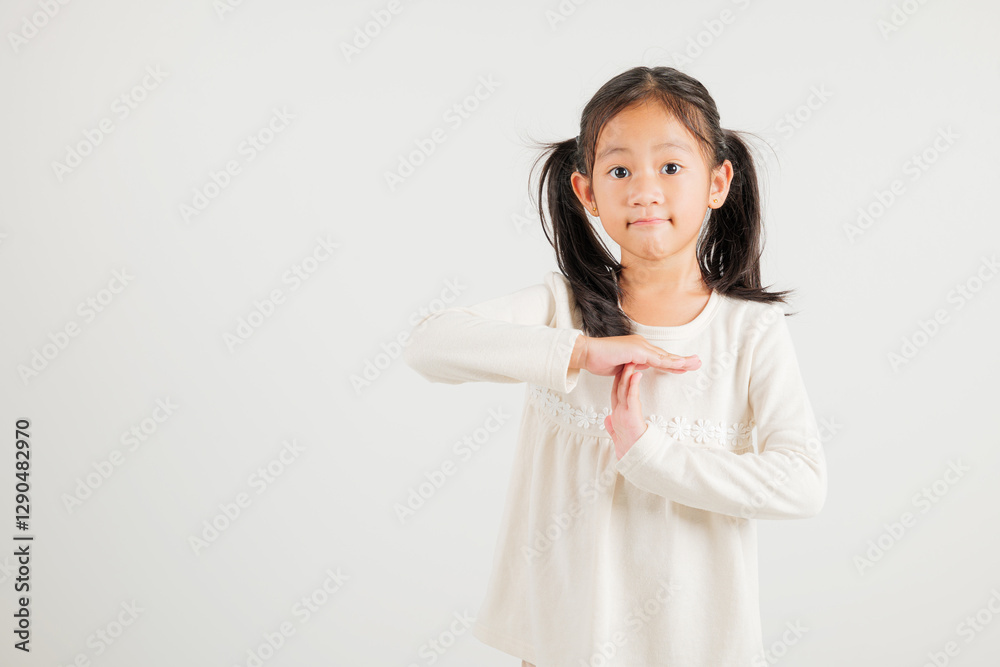 Closeup portrait young kid girl smiling making give time out gesture with hands studio shot isolated on white background, kindergarten child demonstrates break hand sign, stop time with copy space Closeup portrait young kid girl smiling making give time out gesture with hands studio shot isolated on white background, kindergarten child demonstrates break hand sign, stop time with copy space