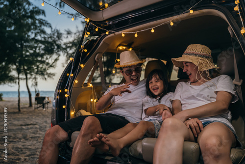 Canvas Print Asian family sitting backseat in car on beach at sunset, funny in holidays and relaxation together