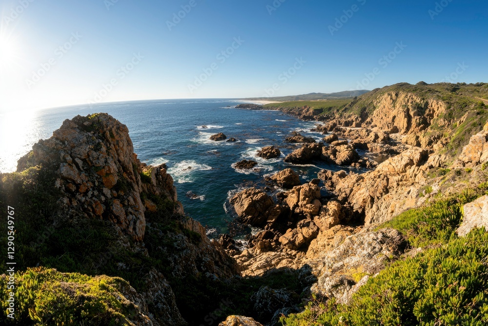 Rocky coastline with crashing waves and vibrant green vegetation in sunny weather Rocky coastline with crashing waves and vibrant green vegetation in sunny weather