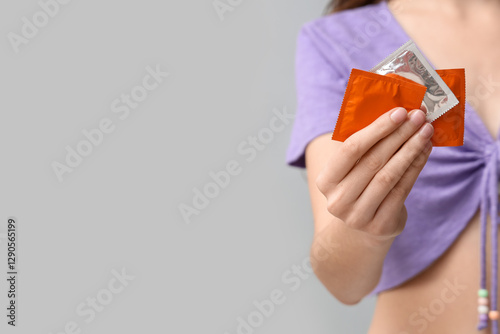 Young woman with condoms on...