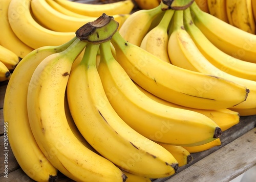 A bunch of ripe bananas arranged together, showcasing their bright yellow color and appealing texture.