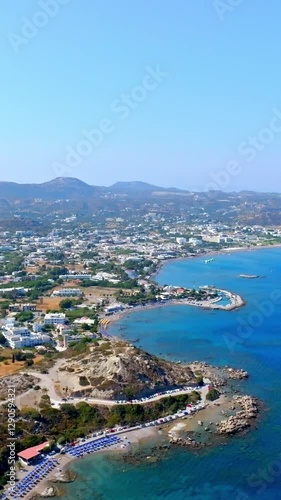 Wallpaper Mural Vertical drone shot backwards over the coastline of Faliraki, sunny day in Rhodes Torontodigital.ca