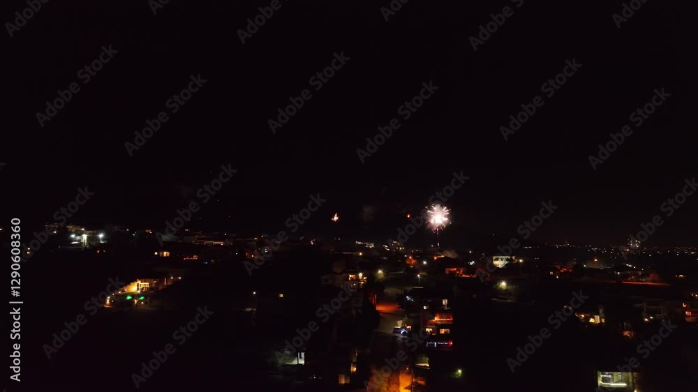 Rooftop perspective over the town with beautiful New Year's Eve fireworks show on the background Rooftop perspective over the town with beautiful New Year's Eve fireworks show on the background