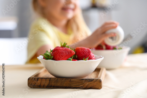 Little girl pouring cream i...