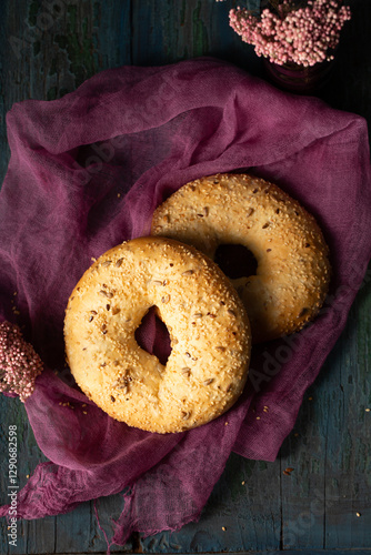 Wallpaper Mural Homemade bagels with sesame, flax and sunflower seeds on burgundy gauze, top view Torontodigital.ca