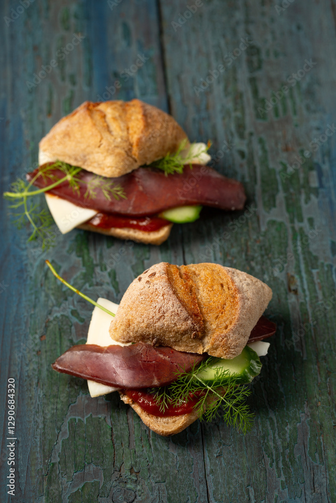 Two small sandwiches with basturma, herbs and cucumber