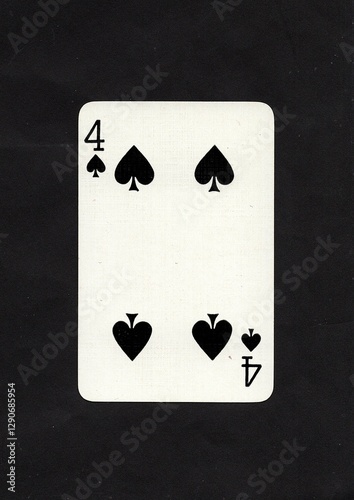 Canvas Print A four of spades playing card on a black background.