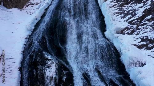  Aerial view of waterfall in the mountains in winter with frozen ice. Rachitele, Romania photo