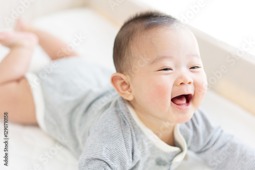 Happy baby playing on bed