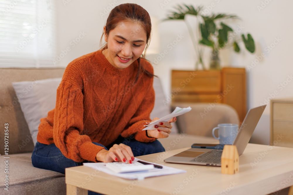 Business asian woman freelancer managing finances and calculating costs at home office, working remotely.Technology of financial Bill pay concept.
