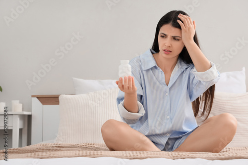Young woman with pill bottl...