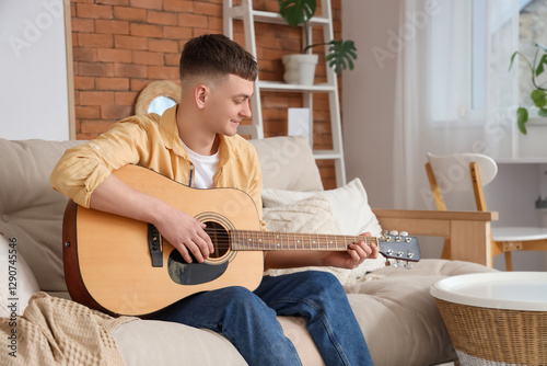 Young man playing guitar on...