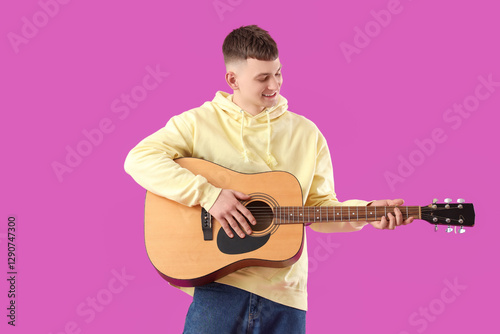 Young man playing guitar on...