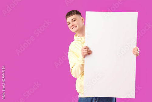 Young man with blank poster...