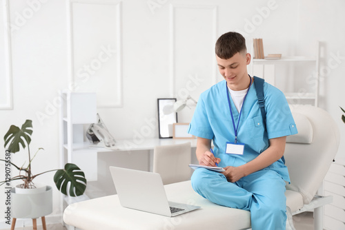 Male medical intern studyin...