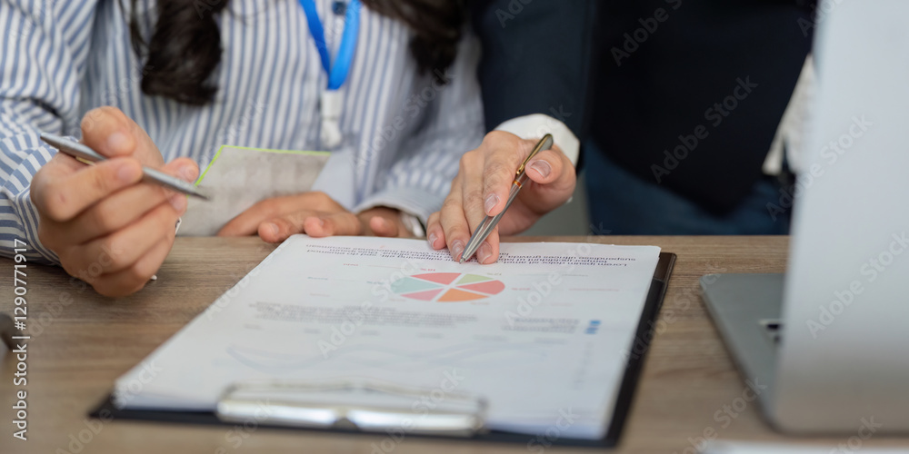 Team collaboration in financial analysis, discussing strategy with charts and notes. Team collaboration in financial analysis, discussing strategy with charts and notes.