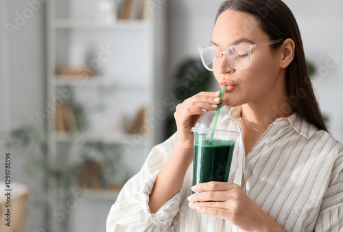 Young woman drinking spirul...