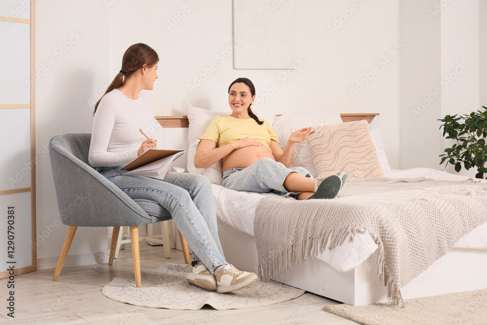 Young pregnant woman with doula lying in bedroom Young pregnant woman with doula lying in bedroom