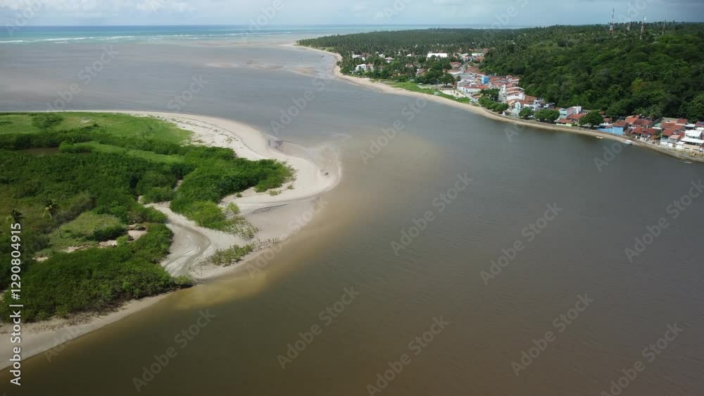 view of Manguaba River surrounded by green lands and small town on a sunny day in Alagoas, Brazil. view of Manguaba River surrounded by green lands and small town on a sunny day in Alagoas, Brazil.
