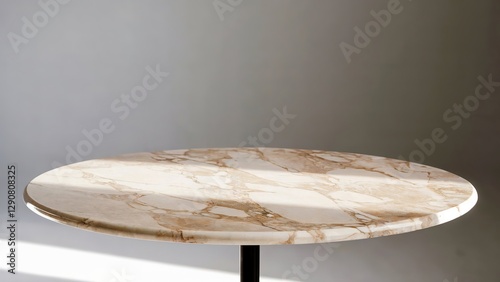 Minimalist round marble table with a modern design, featuring a smooth polished surface with elegant natural veins, illuminated by soft sunlight in a neutral interior setting.
 photo