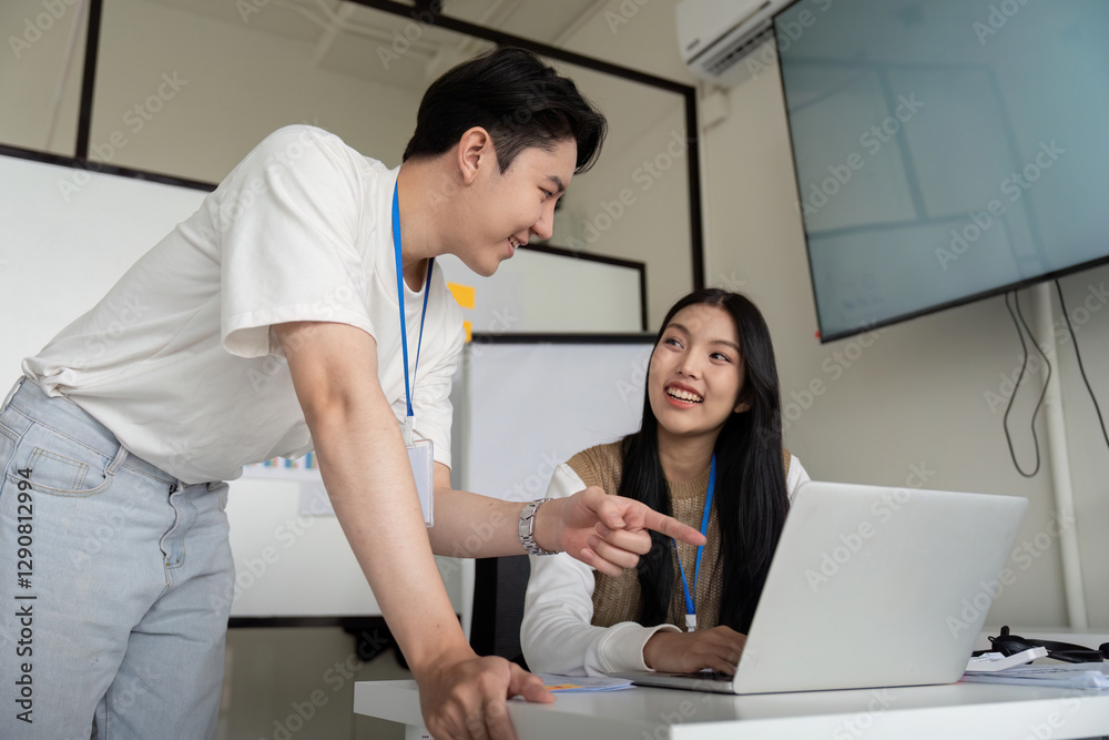 Colleagues discussing financial strategies while reviewing data on a laptop in a meeting. Colleagues discussing financial strategies while reviewing data on a laptop in a meeting.