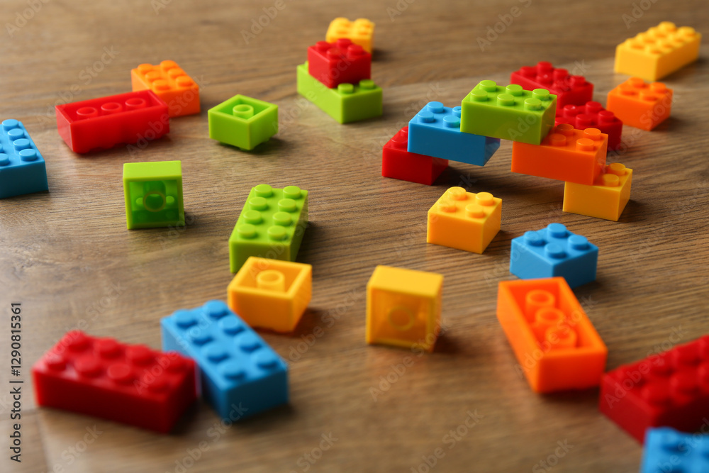 Construction toy. Colorful building bricks on wooden table, closeup Construction toy. Colorful building bricks on wooden table, closeup