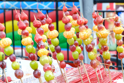 Tanghulu or Tang hulu also called bingtang hulu, consisting of several sugar-coated fruits, a traditional Chinese delicacy, fruit skewers
 photo