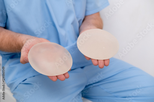 Canvas-taulu doctor holding breast enlargement implant in hands, plastic surgery concept, bea