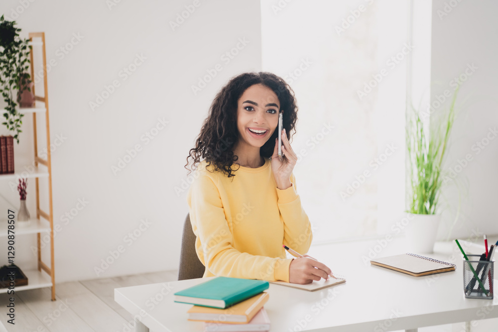 Photo portrait of teenager young wavy hair american girl calling friend for help sitting workplace doing homework for college indoors Photo portrait of teenager young wavy hair american girl calling friend for help sitting workplace doing homework for college indoors