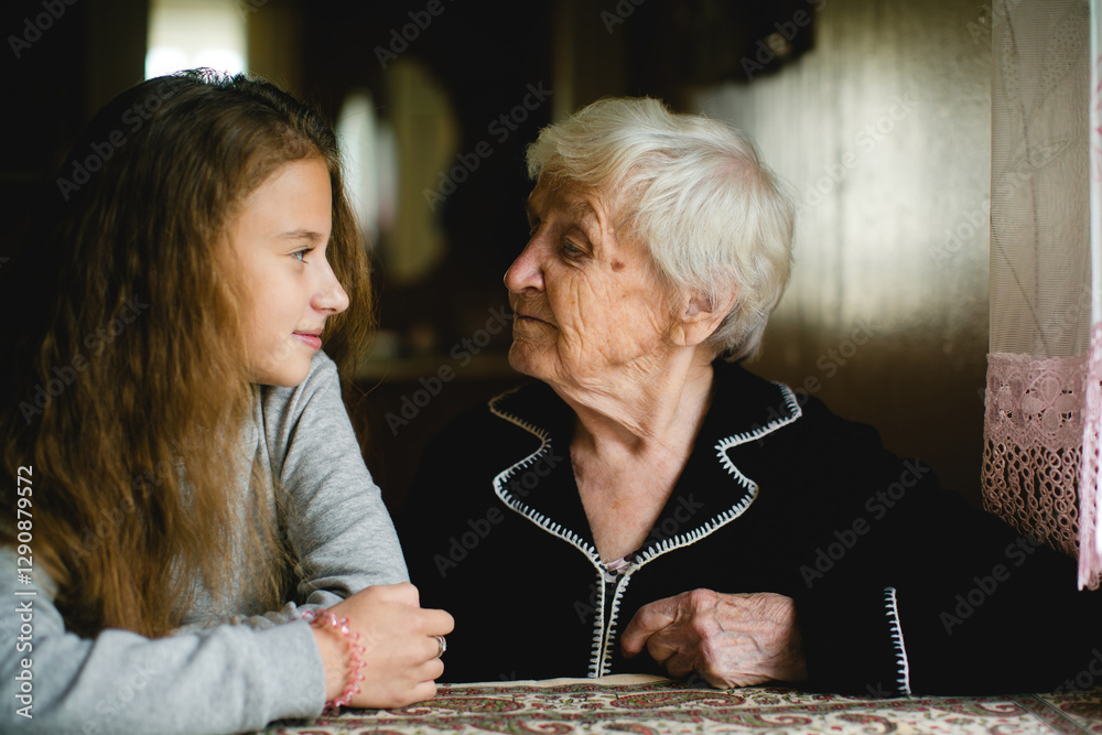 A teenage girl and her grandmother (or great-grandmother) spending time together.