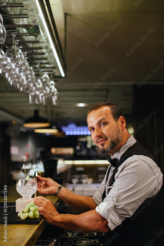 Skilled bartender crafting cocktails in elegant bar setting Skilled bartender crafting cocktails in elegant bar setting