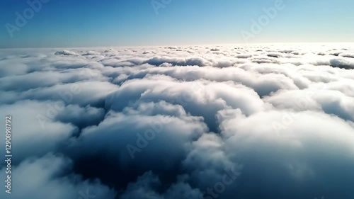 Witness a breathtaking view of fluffy clouds covering the sky in a stunning formation. The bright blue background enhances the calming scene, inviting reflection and tranquility.