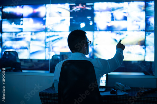 CCTV officers are sitting and checking images from CCTV cameras that appear on many screens.