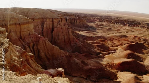 Aerial drone footage of Tsagaan Suvarga, Mongolia's Mars-like landscapes, showcasing stunning cliffs and desert terrain glowing at sunset.