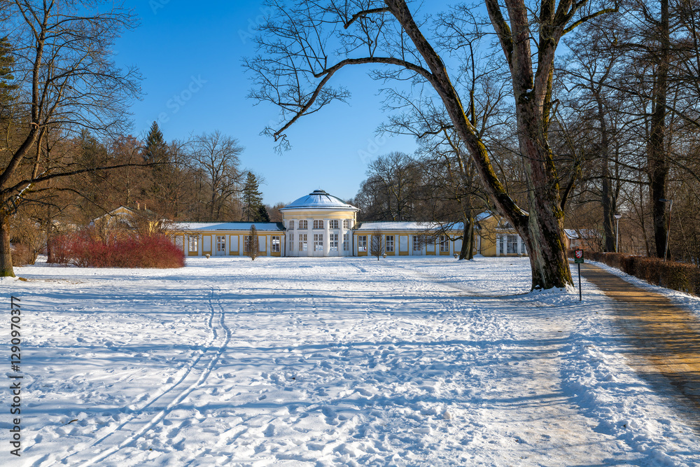 Small colonnade in Marianske Lazne (Marienbad) - snow winter in spa park. Spa architecture - colonnade of cold mineral water spring Ferdinand - Czech Republic, Europe