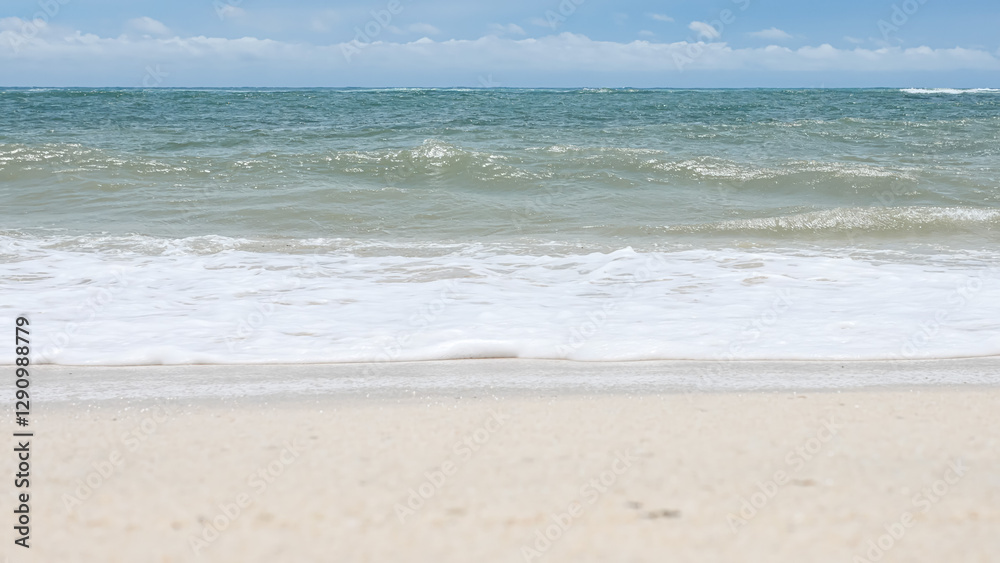 BALI, INDONESIA - JANUARY 22, 2018: Natural white clean sand of Pandava Beach and Indian Ocean waves, Bali. BALI, INDONESIA - JANUARY 22, 2018: Natural white clean sand of Pandava Beach and Indian Ocean waves, Bali.