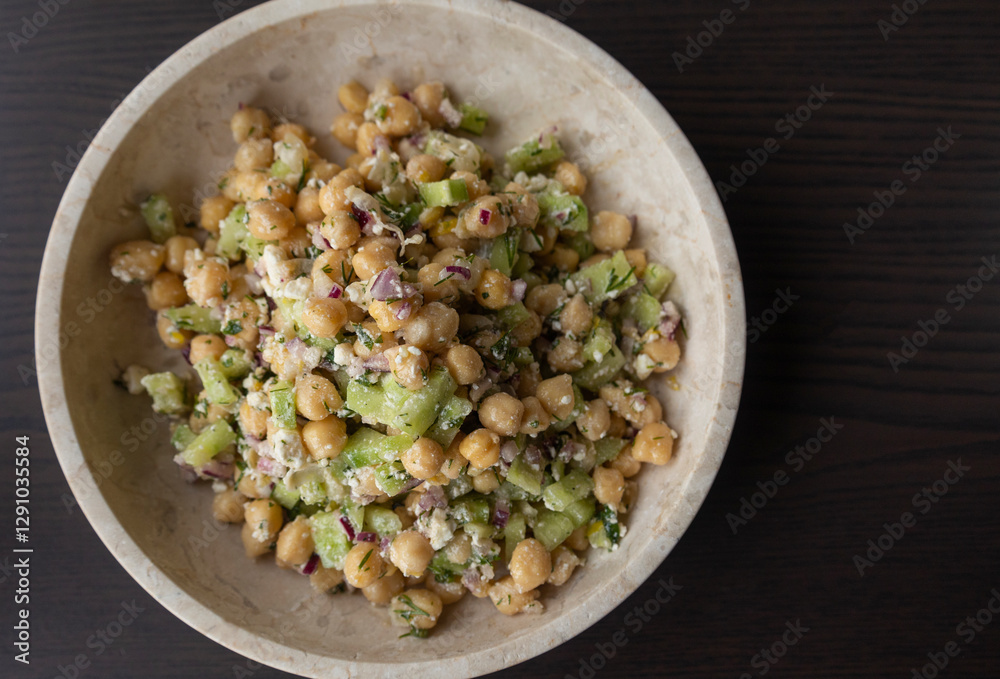 delicious healthy salad with chickpeas, cucumber, and feta cheese close-up delicious healthy salad with chickpeas, cucumber, and feta cheese close-up