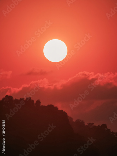 Orange sunset over silhouette mountain horizon