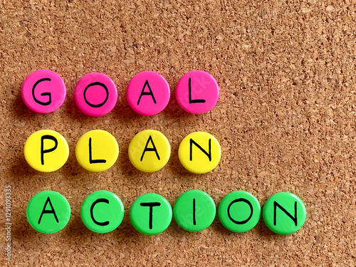 Inspirational and Motivational Success Quote - GOAL PLAN ACTION on colorful thumbtacks background. Stock photo.