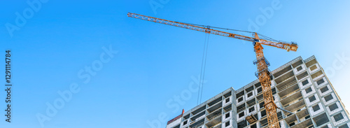 Construction of modern apartments. Construction site with cranes banner background
