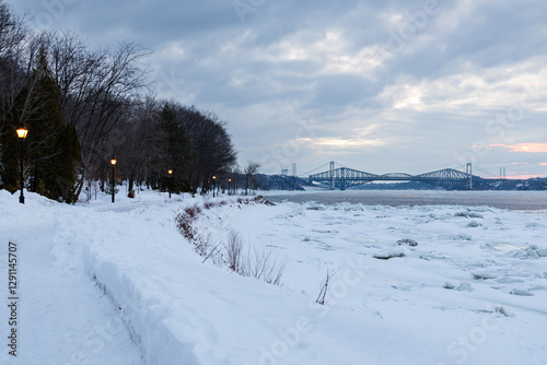 Blue hour morning winter view of the Jacques-Cartier Walk along the St. Lawrence River, with the Pierre-Laporte and Quebec bridges in the background, Quebec City, Quebec, Canada