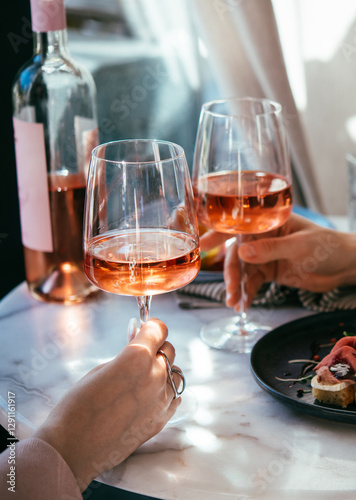 Glasses of rose wine seen during a friendly party or a celebration in a restaurant of a bar.