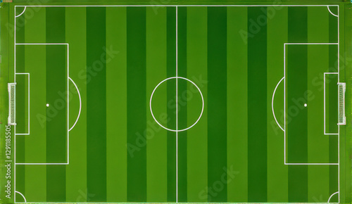 Aerial view of green soccer field with clearly marked lines and goals. field is divided into two halves with central circle and penalty areas photo