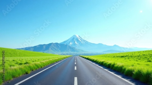 Fototapeta Naklejka Na Ścianę i Meble -  Asphalt road leading to a snow-capped mountain under a vibrant blue sky, flanked by lush green meadows, a picturesque summer landscape