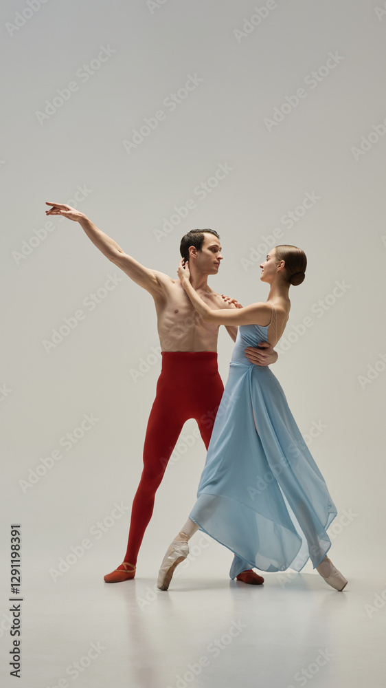 Fototapeta premium Ballet partners moving in perfect unison, gazes locked, hands delicately connected, elegance captured in fluid pose against white studio background. Concept of beauty, trust, synchronization, art.