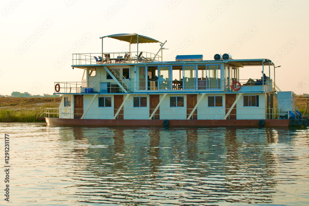 cruise ship on Kwando River, Botswana. Shortly before sunset cruise ship on Kwando River, Botswana. Shortly before sunset