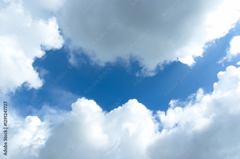 Thick clouds behind the hot sun. Beautiful white clouds in the bright blue sky as a natural concept. Thick clouds behind the hot sun. Beautiful white clouds in the bright blue sky as a natural concept.